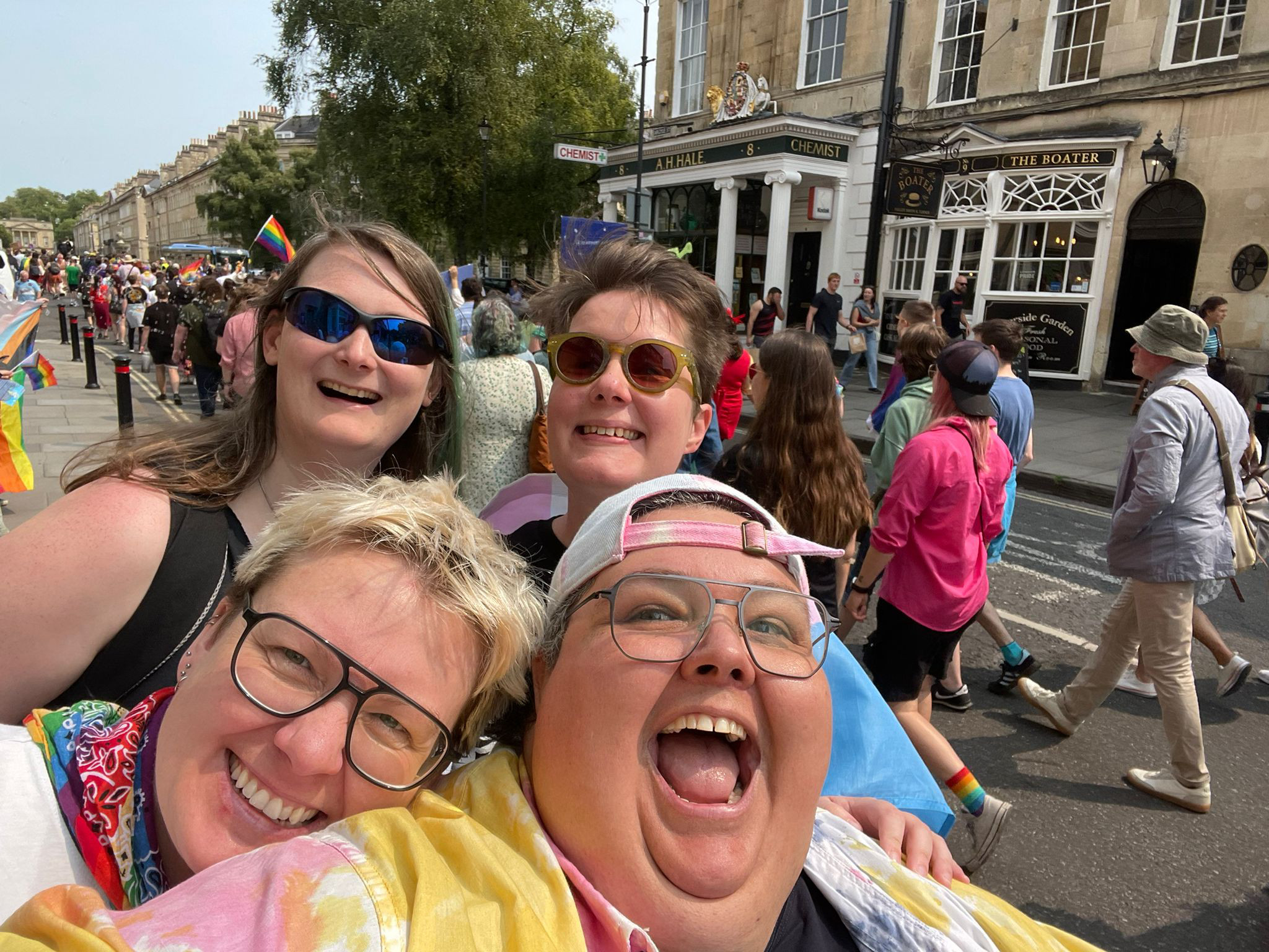 Photo of four happy people at Pride.